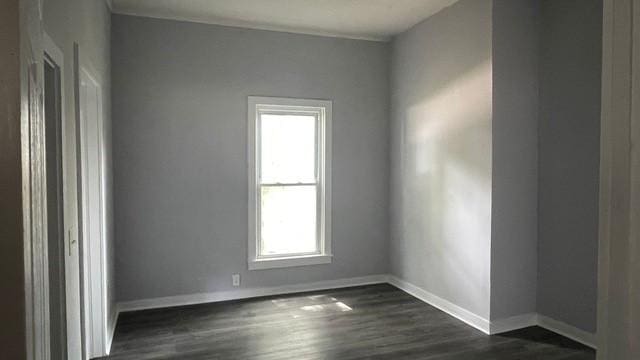 1120 W Robinson St, Alvin, TX 77511 - unfurnished room with baseboards and dark wood-style flooring