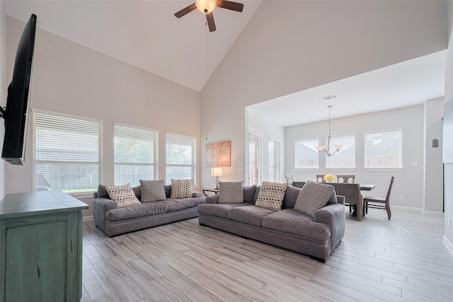 11023 Honey Suckle Haven Dr, Cypress, TX 77433 - living room with a chandelier, a ceiling fan, high vaulted ceiling, and light wood-style floors