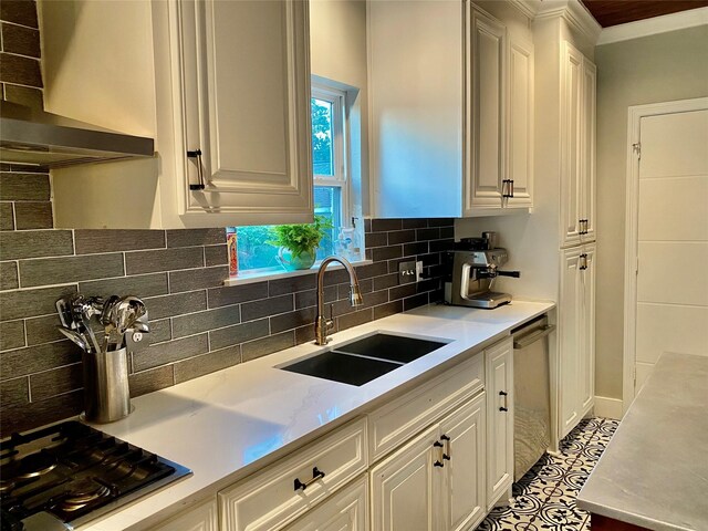 3359 Ozark St, Houston, TX 77021 - kitchen featuring stainless steel appliances, wall chimney exhaust hood, light countertops, white cabinets, and decorative backsplash