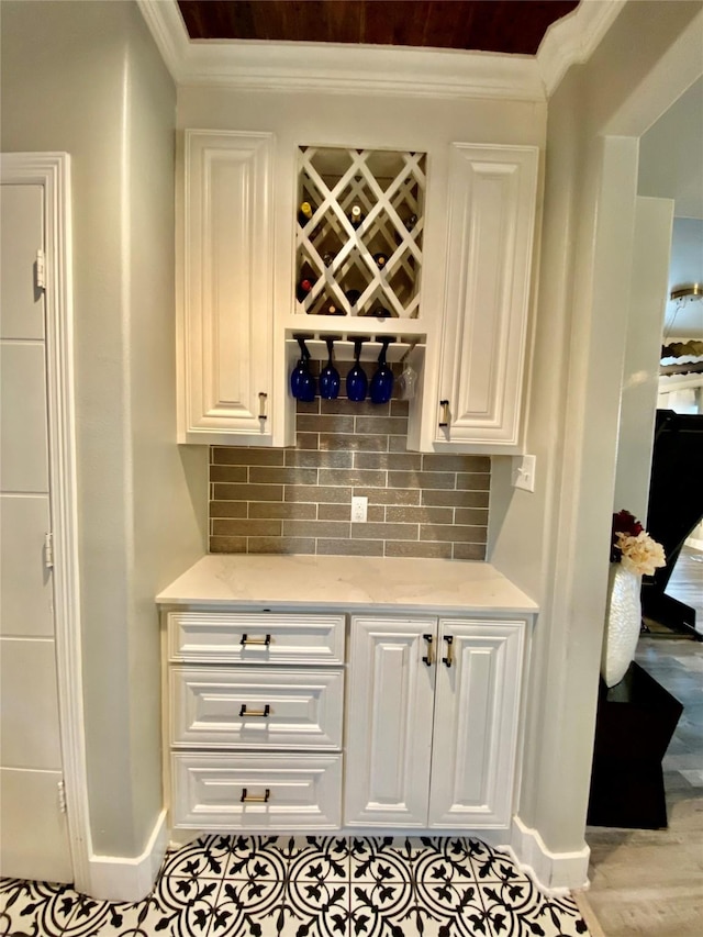 3359 Ozark St, Houston, TX 77021 - bar featuring ornamental molding, backsplash, and light wood-style flooring