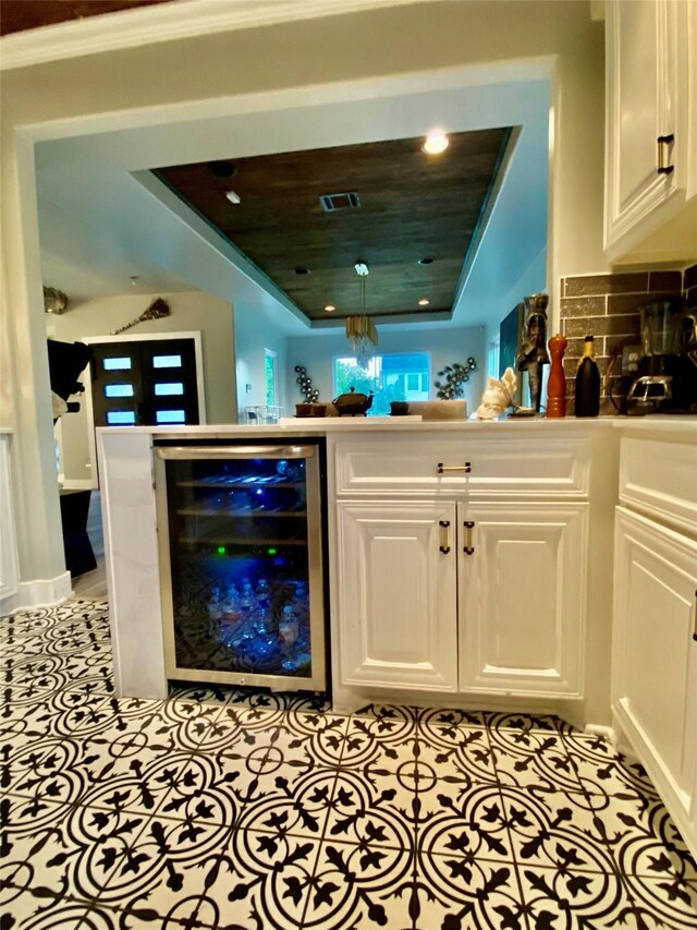 3359 Ozark St, Houston, TX 77021 - indoor dry bar featuring beverage cooler, a raised ceiling, decorative backsplash, and recessed lighting