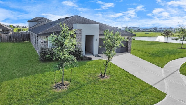 29506 Hartman Holw, Katy, TX 77494 - view of front of property featuring concrete driveway, a garage, roof with shingles, and a water view