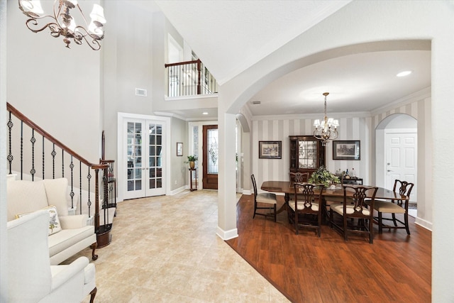 15410 Stable Star Cir, Cypress, TX 77429 - dining area with a chandelier, arched walkways, crown molding, french doors, and wood finished floors