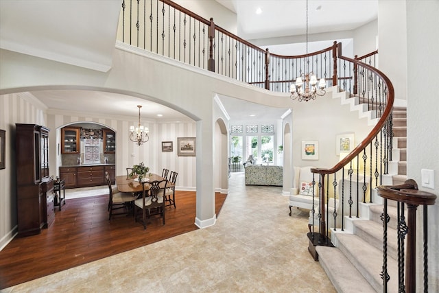 15410 Stable Star Cir, Cypress, TX 77429 - dining room with a chandelier, stairs, arched walkways, crown molding, and wood finished floors