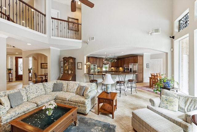 15410 Stable Star Cir, Cypress, TX 77429 - living area with a towering ceiling, arched walkways, light tile patterned floors, ceiling fan, and recessed lighting