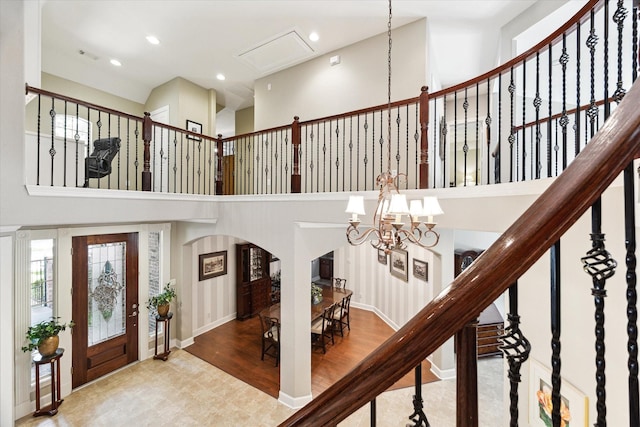 15410 Stable Star Cir, Cypress, TX 77429 - foyer featuring arched walkways, a chandelier, a high ceiling, and recessed lighting