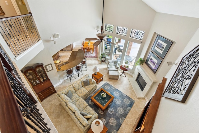 15410 Stable Star Cir, Cypress, TX 77429 - tiled living room featuring a high ceiling, a ceiling fan, and a tiled fireplace