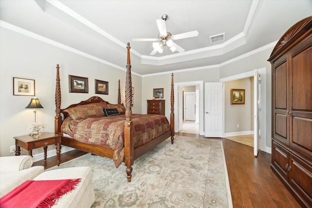 15410 Stable Star Cir, Cypress, TX 77429 - bedroom featuring a tray ceiling, wood finished floors, crown molding, and a ceiling fan