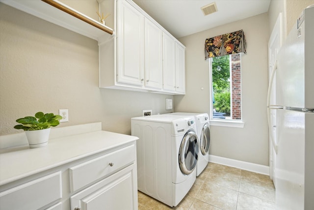 15410 Stable Star Cir, Cypress, TX 77429 - laundry room with washing machine and dryer, cabinet space, and light tile patterned floors