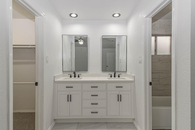 3805 Youpon Dr, La Porte, TX 77571 - full bathroom featuring double vanity, a walk in closet, marble look tile flooring, and a ceiling fan