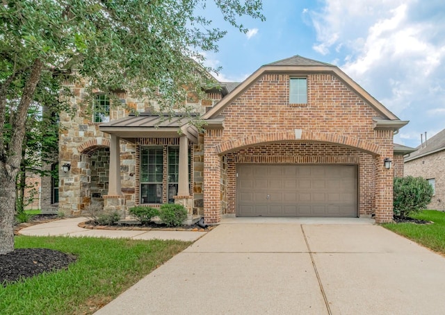 4311 Walden Terrace Ln, Humble, TX 77396 - view of front of home featuring concrete driveway, brick siding, a standing seam roof, and stone siding