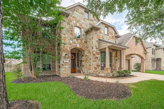 4311 Walden Terrace Ln, Humble, TX 77396 - view of front of house with stone siding, brick siding, and a shingled roof