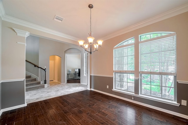 4311 Walden Terrace Ln, Humble, TX 77396 - empty room featuring arched walkways, wood finished floors, stairway, crown molding, and a chandelier