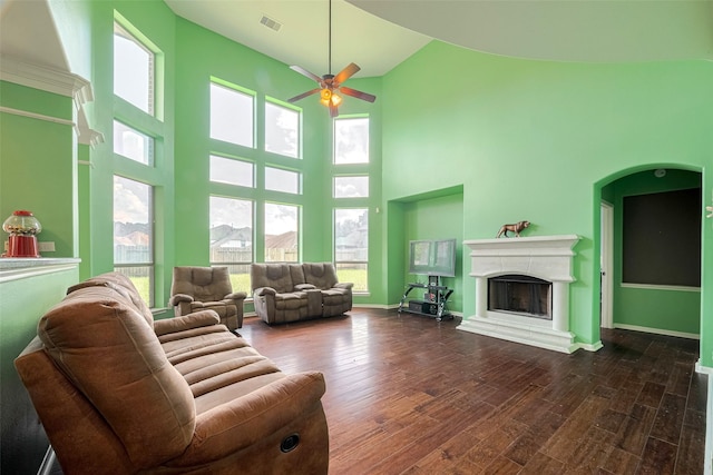 4311 Walden Terrace Ln, Humble, TX 77396 - living area with a ceiling fan, high vaulted ceiling, dark wood-style flooring, and a fireplace with raised hearth