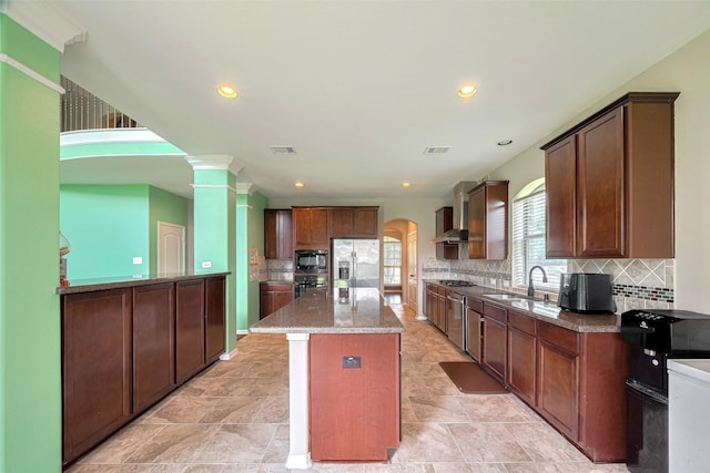 4311 Walden Terrace Ln, Humble, TX 77396 - kitchen featuring appliances with stainless steel finishes, a kitchen island, backsplash, recessed lighting, and stone counters
