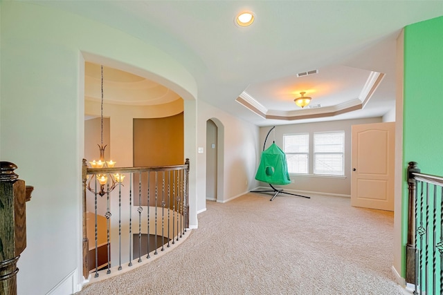 4311 Walden Terrace Ln, Humble, TX 77396 - hall featuring a chandelier, carpet flooring, a raised ceiling, an upstairs landing, and crown molding