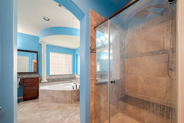 4311 Walden Terrace Ln, Humble, TX 77396 - bathroom featuring a bath, a stall shower, and decorative columns