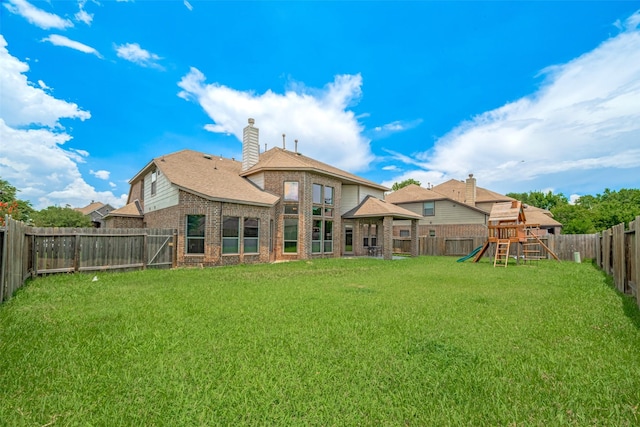 4311 Walden Terrace Ln, Humble, TX 77396 - back of house with brick siding, a playground, a fenced backyard, and a chimney