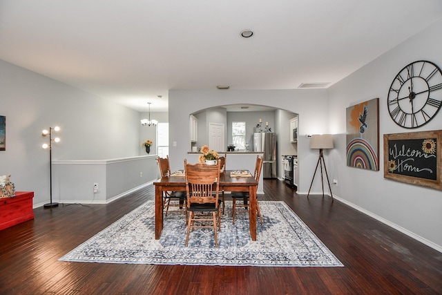 2424 Charleston St Unit D, Houston, TX 77021 - dining room featuring arched walkways, a chandelier, and wood finished floors