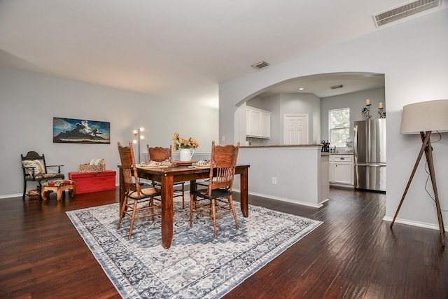 2424 Charleston St Unit D, Houston, TX 77021 - dining space featuring arched walkways and dark wood-style flooring