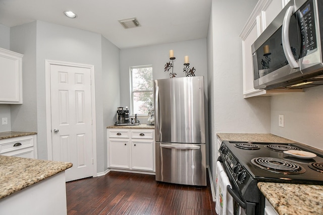 2424 Charleston St Unit D, Houston, TX 77021 - kitchen with stainless steel appliances, dark wood-style floors, white cabinets, light stone countertops, and recessed lighting