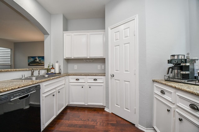 2424 Charleston St Unit D, Houston, TX 77021 - kitchen featuring black dishwasher, dark wood-style floors, white cabinetry, arched walkways, and light stone counters