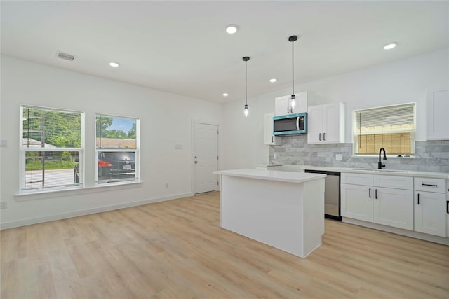 7504 Laura Koppe Rd C/D, Unit C/D Houston, TX 77028 - kitchen with stainless steel appliances, decorative backsplash, plenty of natural light, light wood-style floors, and recessed lighting
