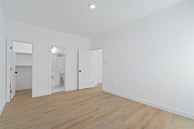 7504 Laura Koppe Rd C/D, Unit C/D Houston, TX 77028 - unfurnished bedroom featuring a spacious closet, light wood finished floors, and connected bathroom