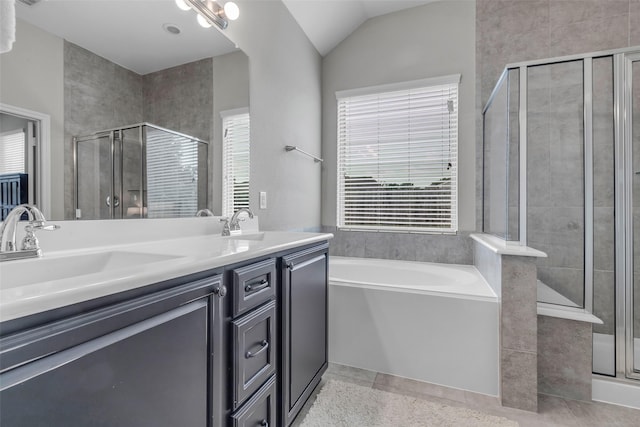 6423 Hunters Creek Ln, Baytown, TX 77521 - bathroom with a stall shower, a bath, double vanity, and vaulted ceiling