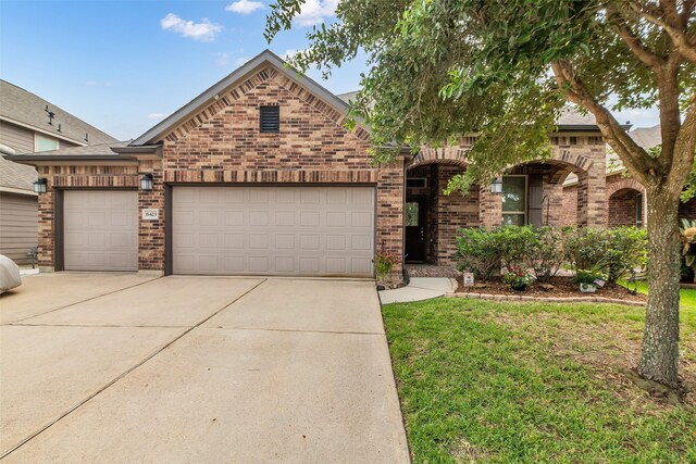 6423 Hunters Creek Ln, Baytown, TX 77521 - view of front of property with brick siding, driveway, a garage, and a front yard