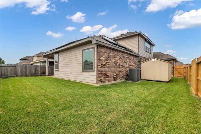6423 Hunters Creek Ln, Baytown, TX 77521 - back of property featuring brick siding, a fenced backyard, a storage unit, and solar panels