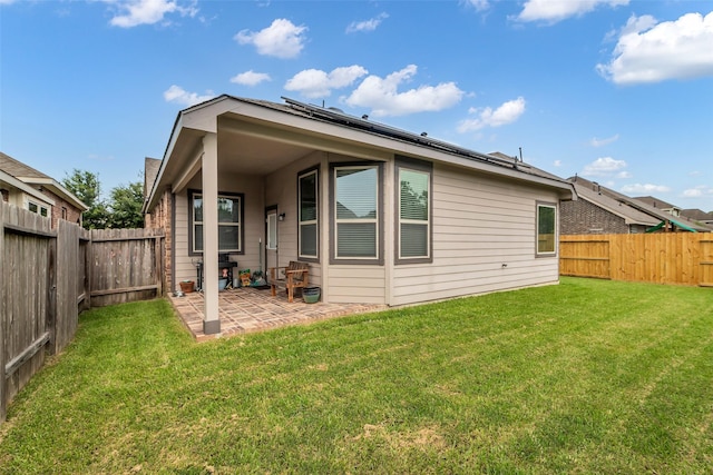 6423 Hunters Creek Ln, Baytown, TX 77521 - back of house featuring a patio area, a fenced backyard, and roof mounted solar panels