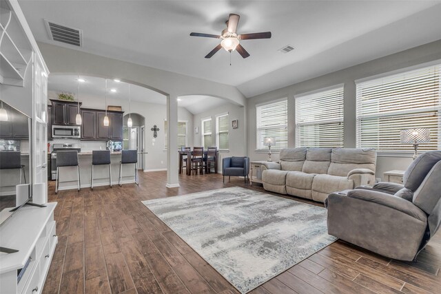 6423 Hunters Creek Ln, Baytown, TX 77521 - living area with arched walkways, ceiling fan, dark wood-style flooring, and vaulted ceiling