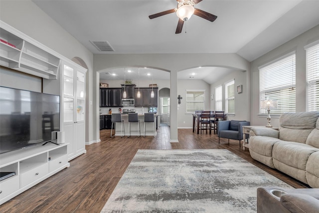 6423 Hunters Creek Ln, Baytown, TX 77521 - living area featuring arched walkways, dark wood-style flooring, ceiling fan, and lofted ceiling
