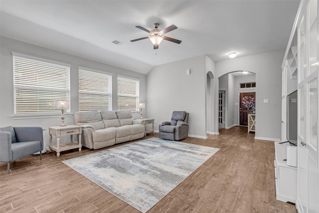 6423 Hunters Creek Ln, Baytown, TX 77521 - living room featuring arched walkways, ceiling fan, light wood finished floors, and vaulted ceiling