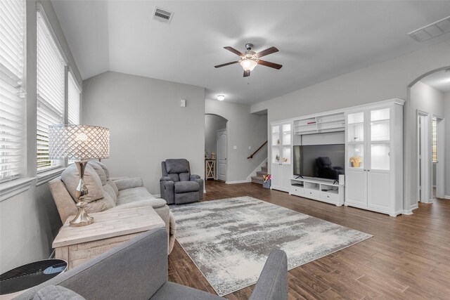 6423 Hunters Creek Ln, Baytown, TX 77521 - living room with arched walkways, a ceiling fan, stairway, and wood finished floors