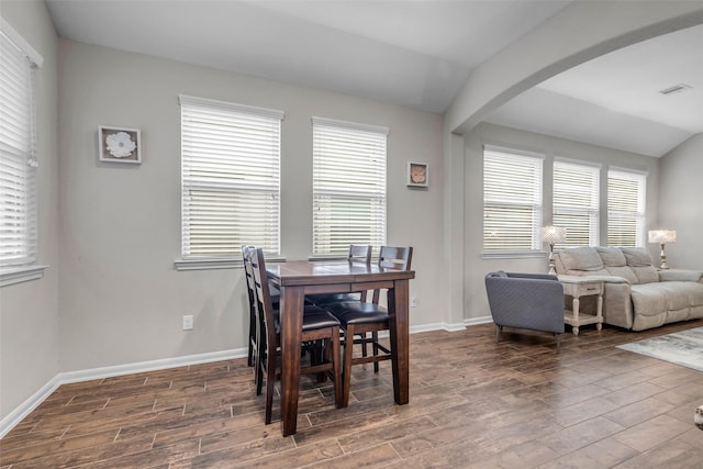 6423 Hunters Creek Ln, Baytown, TX 77521 - dining space featuring wood finished floors, arched walkways, and healthy amount of natural light