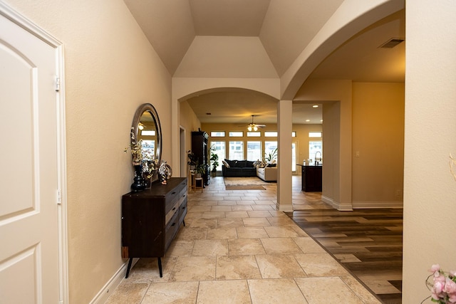 4015 Teramo Ln, Katy, TX 77493 - corridor featuring stone tile flooring, arched walkways, and lofted ceiling