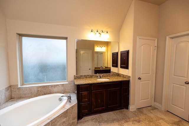 4015 Teramo Ln, Katy, TX 77493 - bathroom with vanity, a bath, and vaulted ceiling