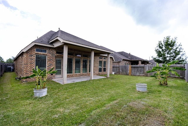 4015 Teramo Ln, Katy, TX 77493 - back of property featuring brick siding, a fenced backyard, a patio, and roof with shingles
