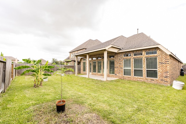 4015 Teramo Ln, Katy, TX 77493 - rear view of house with brick siding, a fenced backyard, a patio, and roof with shingles