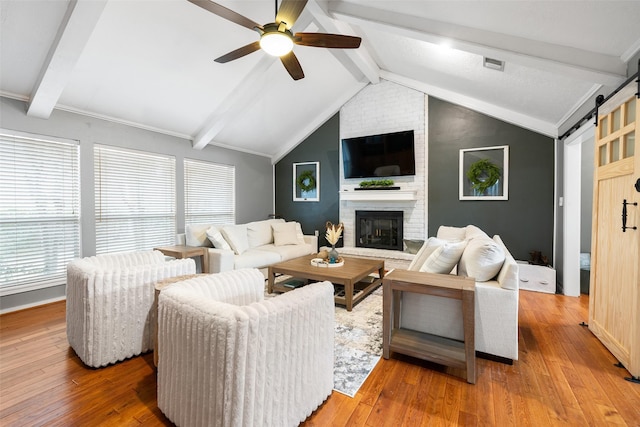 6702 Seinfeld Ct, Houston, TX 77069 - living room featuring a ceiling fan, a barn door, plenty of natural light, and a fireplace