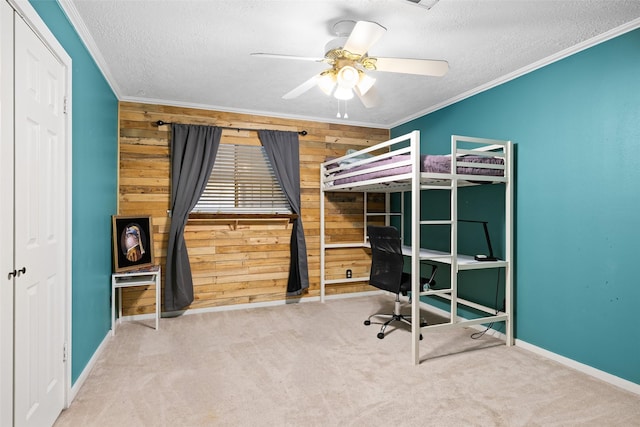 6702 Seinfeld Ct, Houston, TX 77069 - carpeted bedroom featuring wood walls, a desk, ornamental molding, a textured ceiling, and a ceiling fan