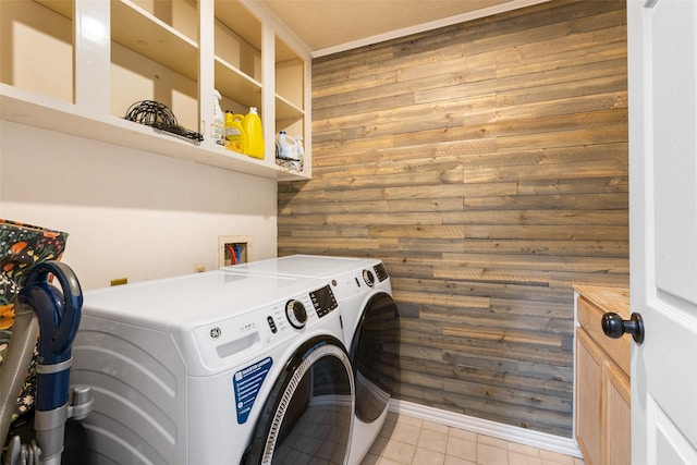 6702 Seinfeld Ct, Houston, TX 77069 - laundry area with washer and clothes dryer, wood walls, and light tile patterned floors
