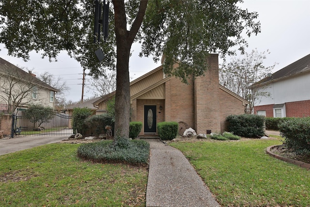 6702 Seinfeld Ct, Houston, TX 77069 - mid-century modern home featuring brick siding, a gate, a chimney, and driveway