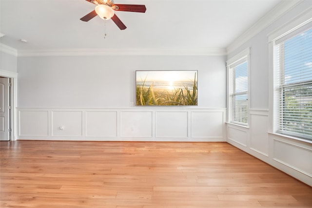 2802 Morrison St Unit 203, Houston, TX 77009 - unfurnished room with ornamental molding, a ceiling fan, a decorative wall, light wood-style floors, and a wainscoted wall