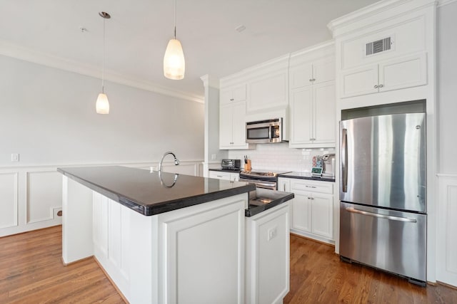 2802 Morrison St Unit 203, Houston, TX 77009 - kitchen with appliances with stainless steel finishes, dark countertops, white cabinetry, decorative backsplash, and crown molding