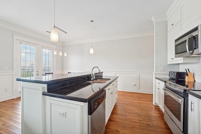 2802 Morrison St Unit 203, Houston, TX 77009 - kitchen featuring stainless steel appliances, dark countertops, crown molding, wood finished floors, and white cabinets