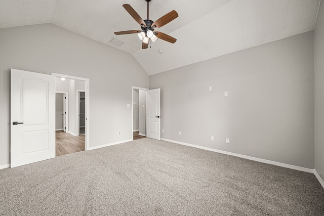 23814 Sawmill Pass, Spring, TX 77373 - unfurnished bedroom with light carpet, vaulted ceiling, and ceiling fan