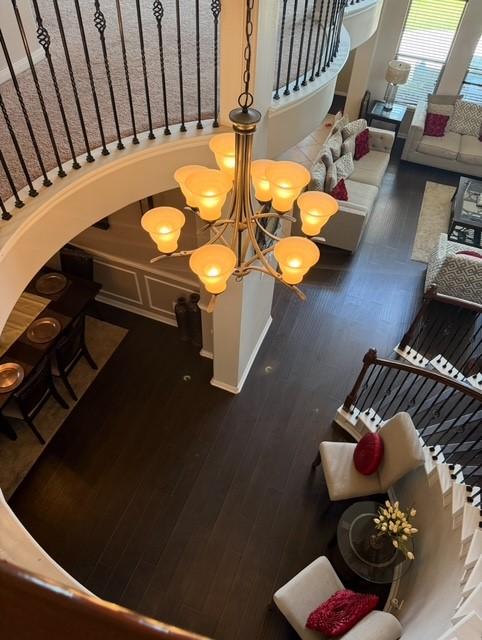 2547 Crystal Shore Dr, Rosharon, TX 77583 - stairway with wood finished floors, a chandelier, and arched walkways